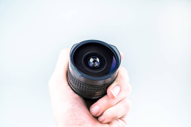 istock Old lens in hands on a white background 1094867528