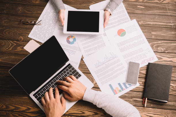 istock top view of businesspeople working with digital devices and documents 1094868012
