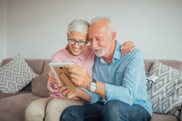 istock Hugging couple looking at photograph 1094868240