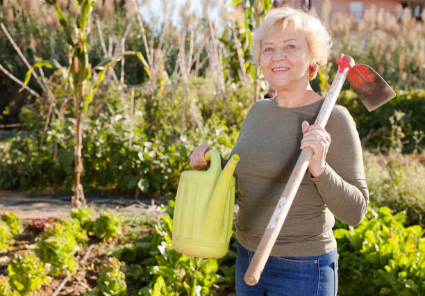 istock Woman holding watering can in her hands 1094869652