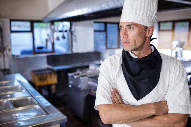 istock Male chef standing with arms crossed in kitchen 1094869864