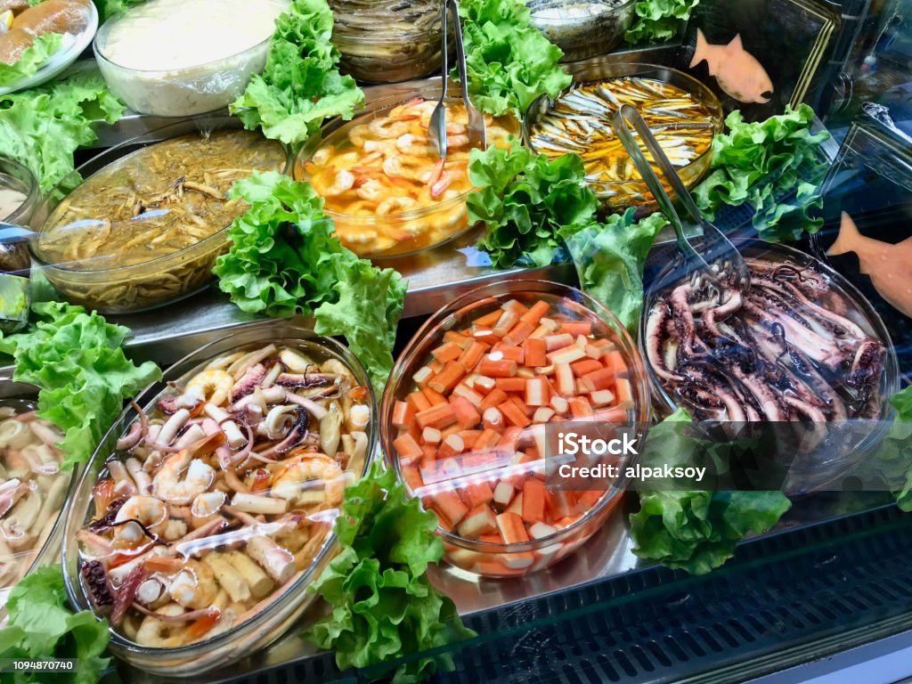 Fresh Seafood Surimi, Octopus, Shrimp and Assorted Fishes Displayed at Showcase of Turkish Bazaar. Fresh Seafood Surimi, Octopus, Shrimp and Assorted Fishes Displayed at Showcase of Turkish Bazaar. Organic Food. Brixton Stock Photo