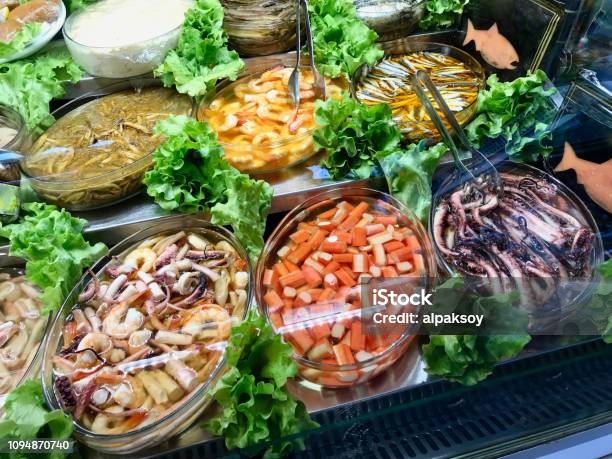 Fresh Seafood Surimi Octopus Shrimp And Assorted Fishes Displayed At Showcase Of Turkish Bazaar Stock Photo - Download Image Now