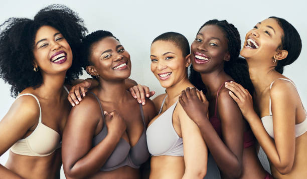 Love yourself and teach others to love themselves as well Studio shot of a group of beautiful young women posing together in their underwear against a grey background short weave hairstyles stock pictures, royalty-free photos & images