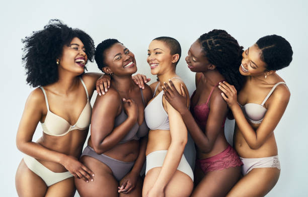 Happiness is being confident in your skin Studio shot of a group of beautiful young women posing together in their underwear against a grey background short weave hairstyles stock pictures, royalty-free photos & images