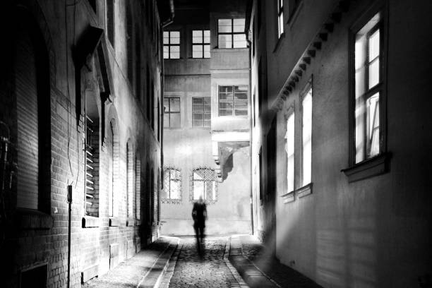 istock A human wanders through a spooky narrow alley in the dark night 1094871902