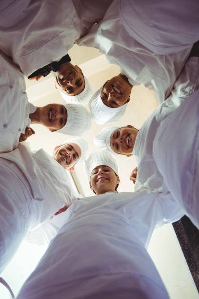 istock Group of chefs formig huddles in kitchen 1094875480