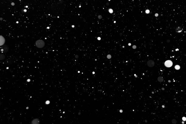 istock Bokeh white snow on a black night background 1094877854