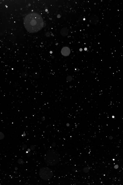 istock Bokeh white snow on a black night background 1094877910