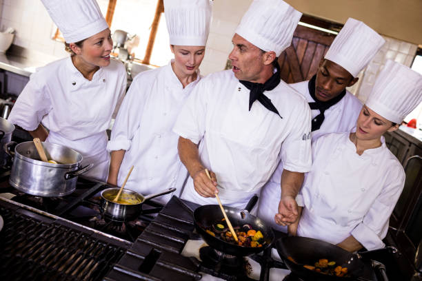istock Group of chefs preparing food in kitchen 1094877960