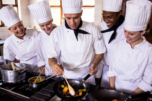 istock Group of chefs preparing food in kitchen 1094878158