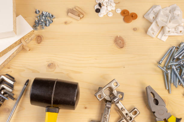 istock Furniture assembly components and tools arranged in a still life on a table. Background with copy space. 1094883514