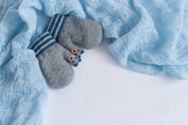 istock Pair of grey knitted mittens on a white background 1094885790