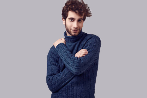istock Handsome elegant man with curly hair in blue sweater 1094886808