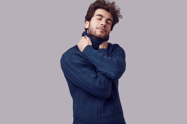 istock Handsome elegant man with curly hair in blue sweater 1094886834