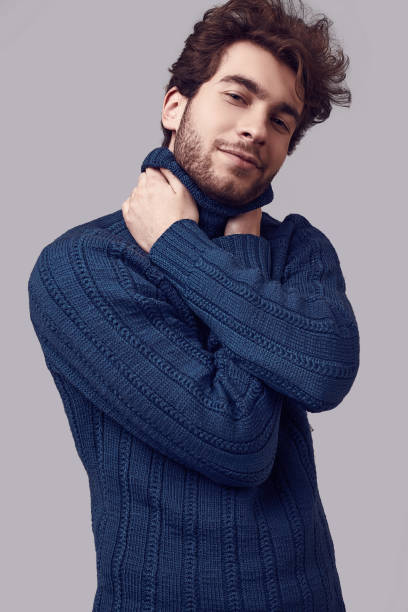istock Handsome elegant man with curly hair in blue sweater 1094886872