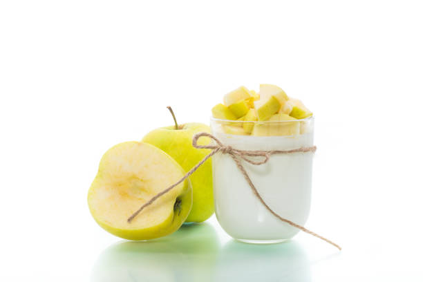 homemade yogurt with ripe apples isolated on white background