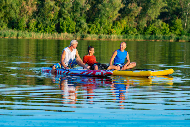 istock Joyful friends, a SUP surfers relax on the big river 1094891636