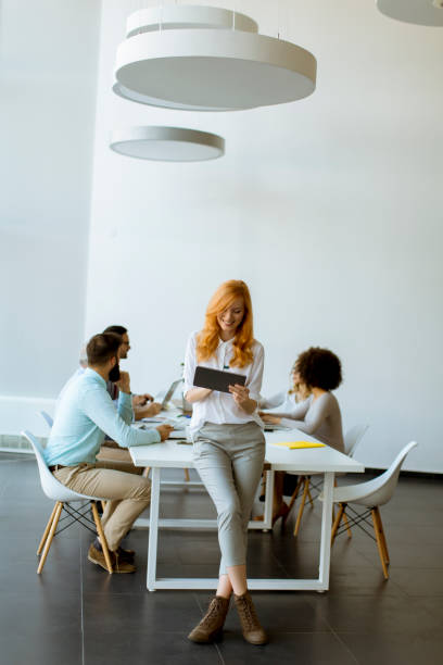 istock Pretty young red hair woman using digital tablet 1094892782