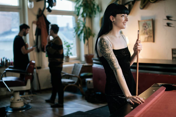 istock Tatooed woman standing at Billiard Table 1094893896