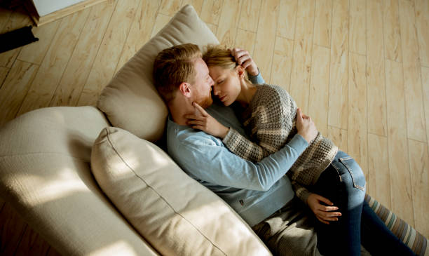 istock Loving couple lying down on the sofa in the room 1094895180