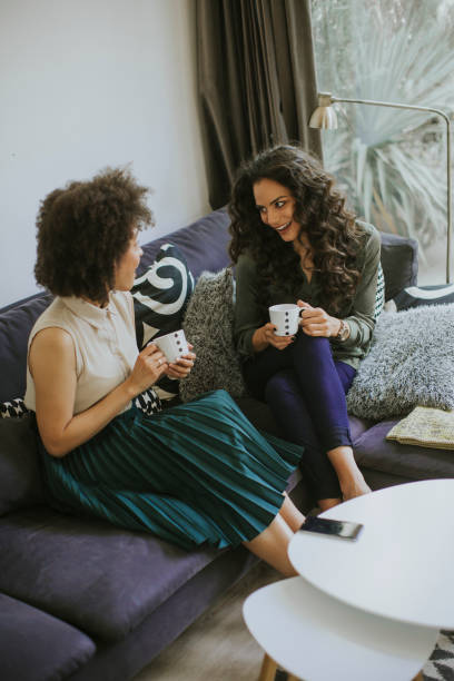 istock Two multiracial young women chatting and drinking coffe 1094895640