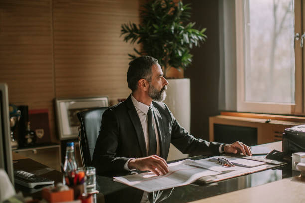istock Senior businessman working in modern office 1094897216