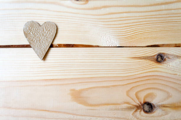 istock Cardboard heart with cracks lying on a wooden background 1094899978