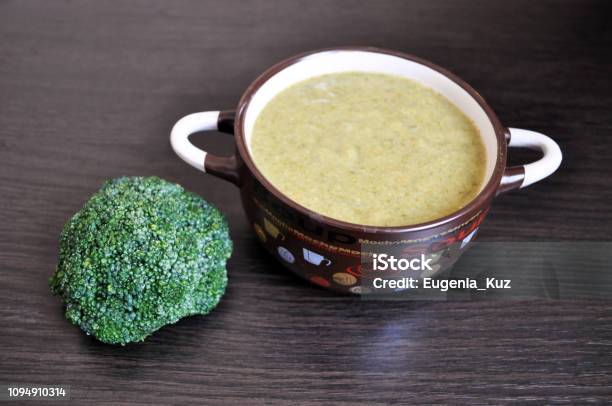 Brown Plate With Broccoli Cream Soup And A Sprig Of Fresh Broccoli Stock Photo - Download Image Now