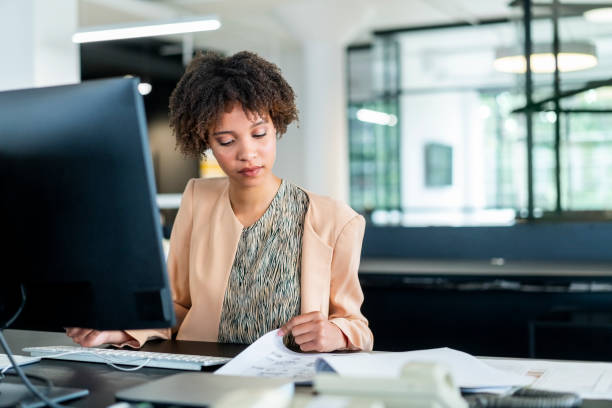 istock Confident young businesswoman reading document 1094910530