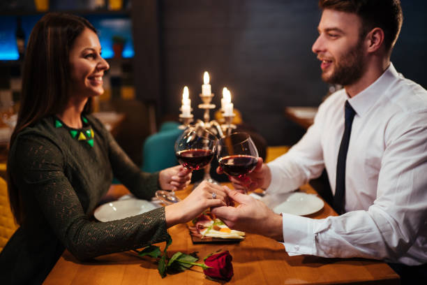 istock Couple toasting with red wine during romantic dinner 1094912486