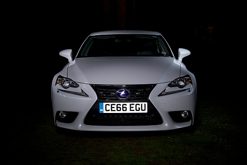 Cardiff, UK: June 01, 2014: A Lexus IS 300h hybrid car parked in a rural location at night.