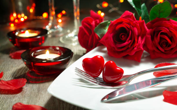 Festive table place setting for Valentines day dinner stock photo