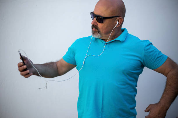 Grandfather taking a selfie while listening to the music on his cellphone