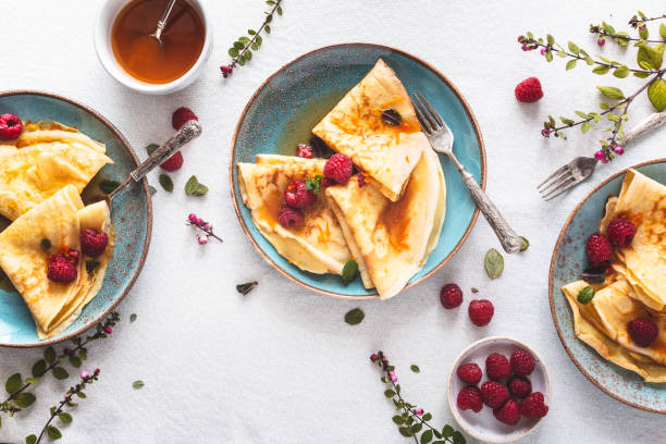 Pancake Suzette Citrus Sauce and Rum and Raspberries for Candlemas Crêpe Suzette Citrus Sauce and Rum and Raspberries for Candlemas crêpe pancake stock pictures, royalty-free photos & images