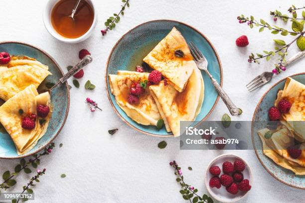 Pancake Suzette Citrus Sauce And Rum And Raspberries For Candlemas Stock Photo - Download Image Now