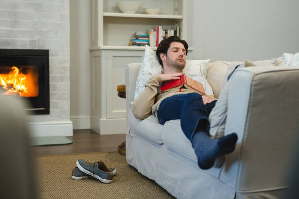 istock Man sleeping on sofa in living room 1094913258