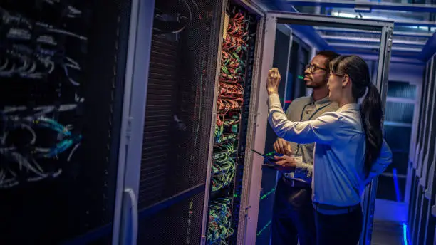 Photo of IT engineers checking servers in server room