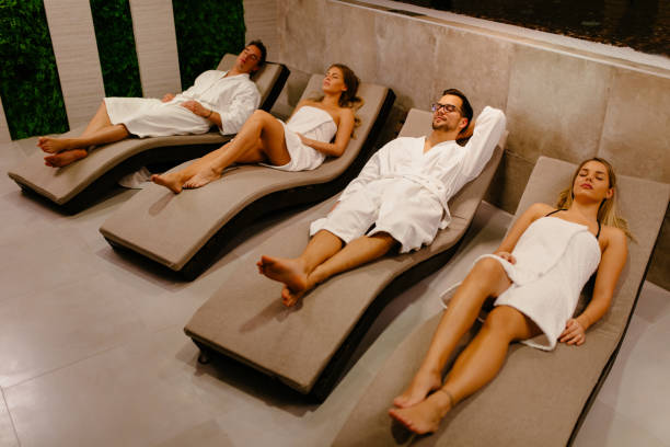istock Two couples relaxing in lounge chairs at spa 1094917564