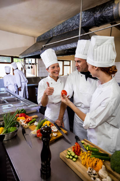 istock Group of chefs interacting with each other in kitchen 1094918310