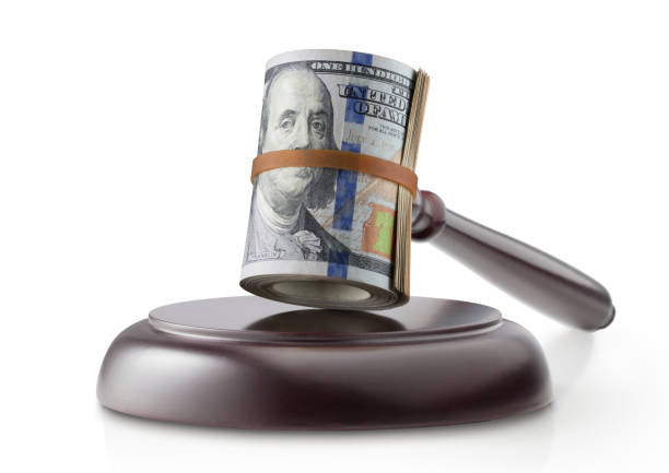 Justice and money. Judge gavel with roll of dollar banknotes on white background. Judge gavel with roll of dollar banknotes on white background. bail law stock pictures, royalty-free photos & images