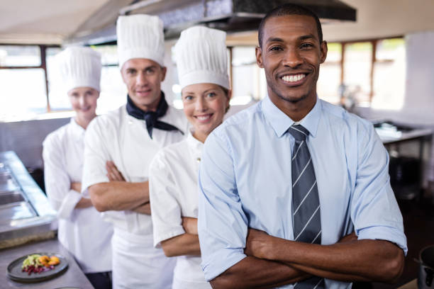 istock Group of chefs and manager standing with arms crossed in kitchen 1094918996