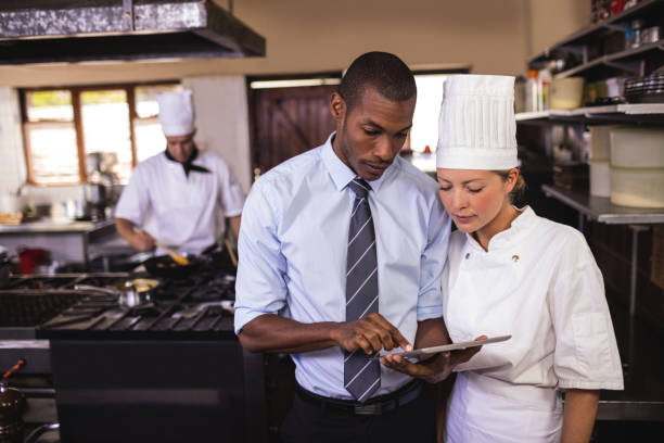 istock Male manager and female chef using digital tablet in kitchen 1094919120