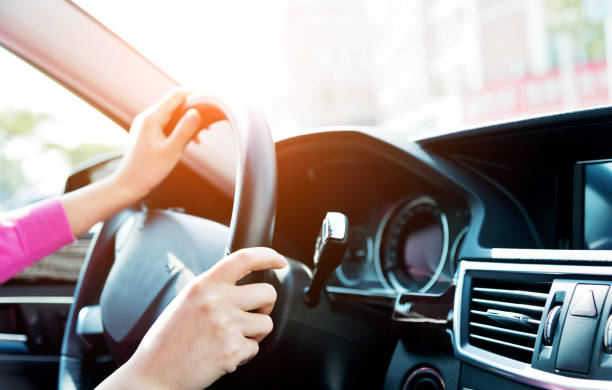 istock Woman hands holding steering wheel 1094919150