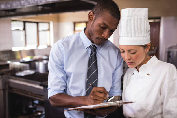 istock Male manager and female chef writing on clipboard in kitchen 1094919200
