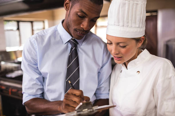 istock Male manager and female chef writing on clipboard in kitchen 1094919254