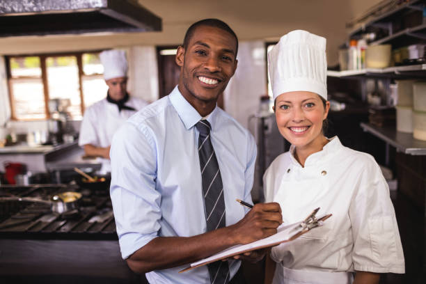 istock Male manager and female chef writing on clipboard in kitchen 1094919464