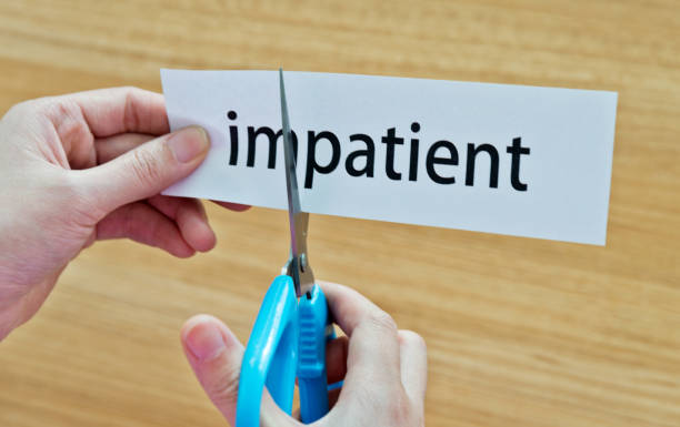 istock Human hand cutting the impatient word 1094922294