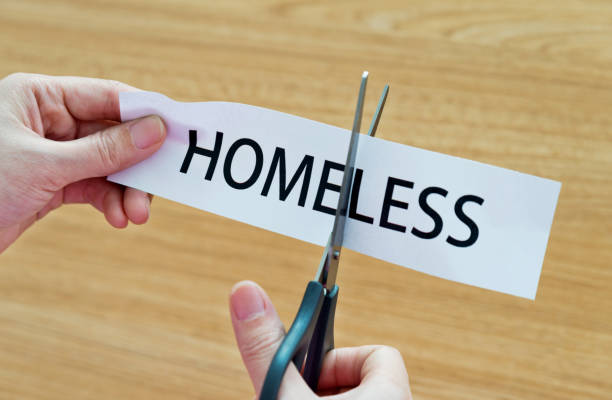 istock Human hand cutting the homeless word 1094922390