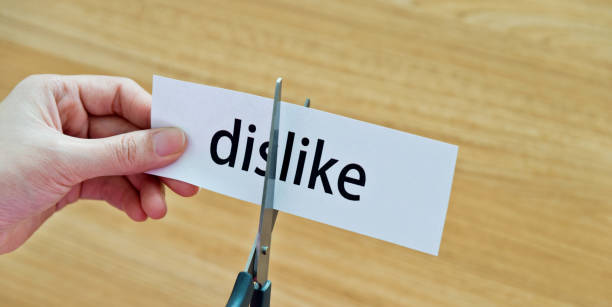 istock Human hand cutting the dislike word 1094922412